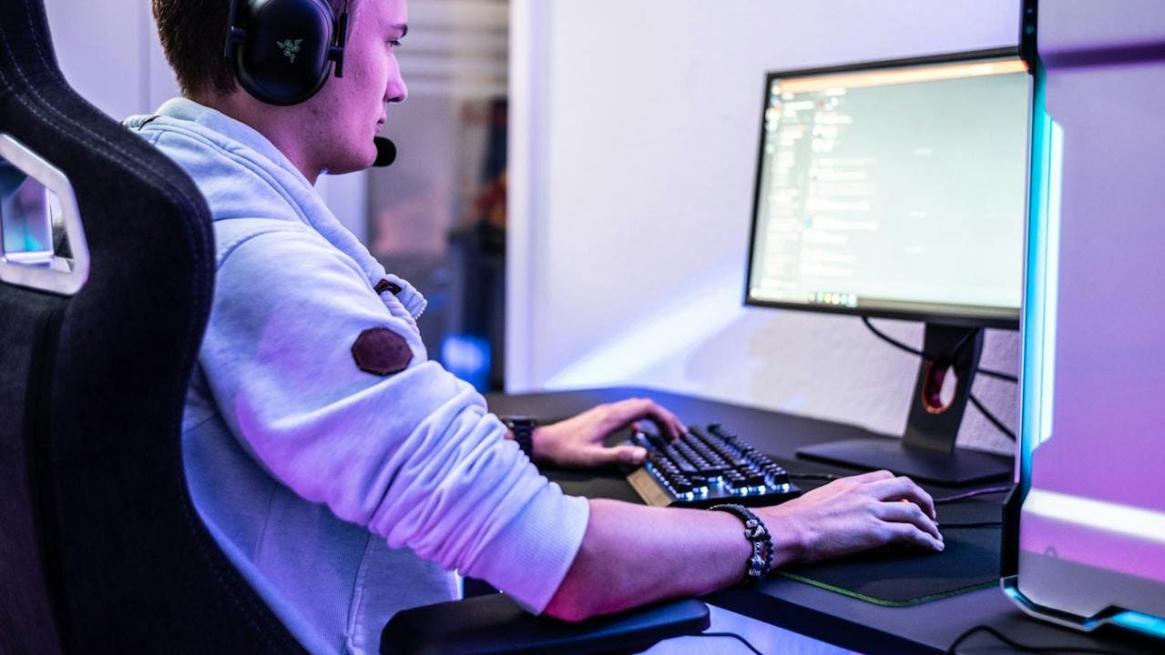 gamer sitting at a standing gaming desk from leetdesk in a healthy posture ergonomic